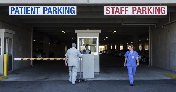 Hospital parking garage entrance with patient and staff parking signage