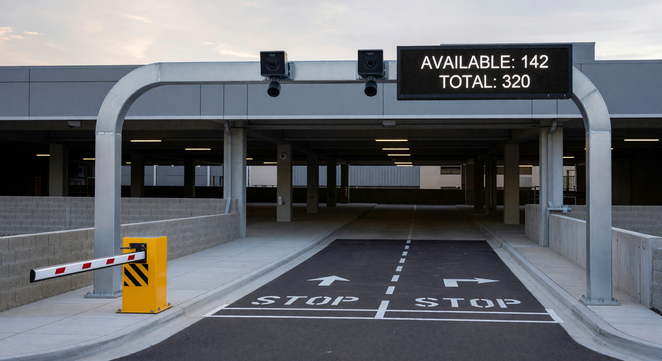 Parking technology installation with camera sensors and digital display at facility entrance